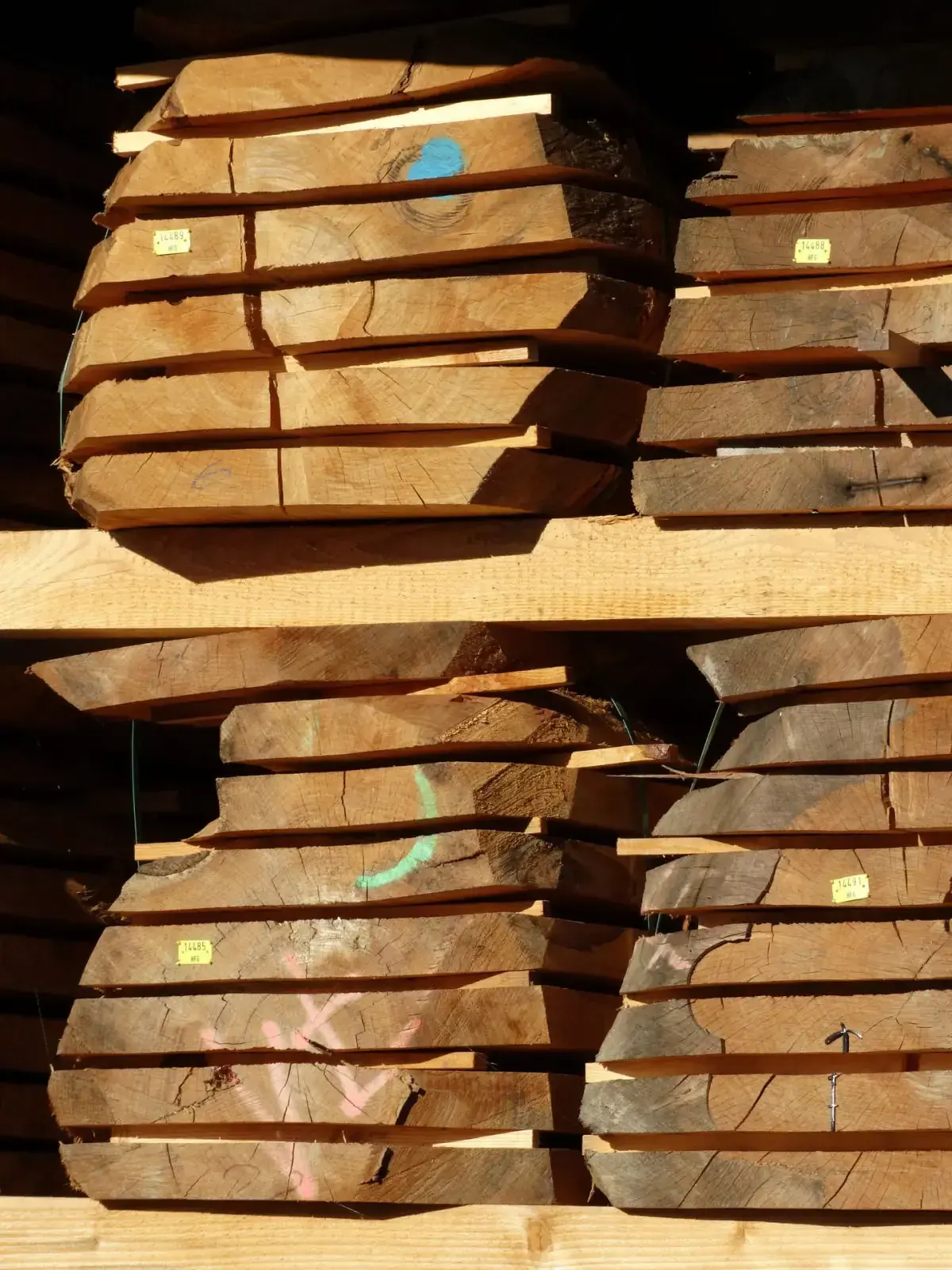 Stacks of live-edge lumber slabs